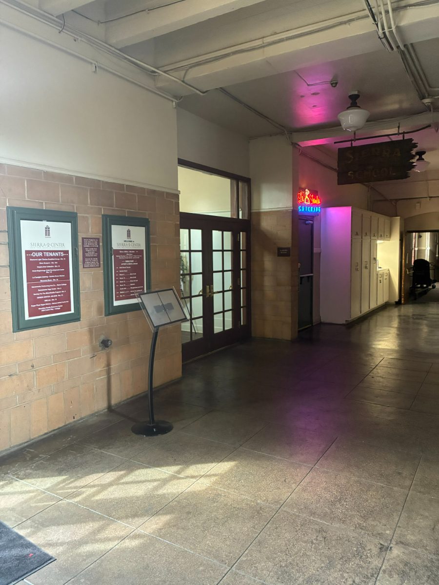 The hallway just inside Sierra 2 Center, with the Garden Room&rsquo;s double glass doors on the left beside the tenant directory boards.